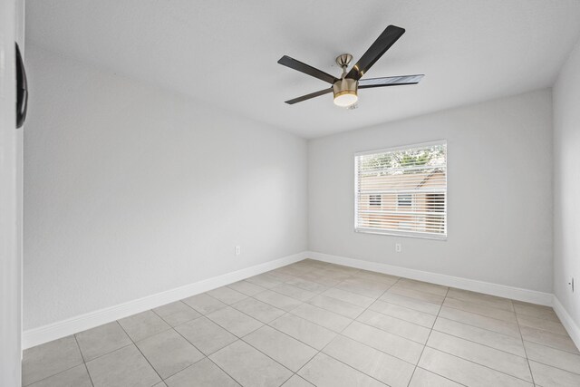 spare room with light tile patterned floors and ceiling fan