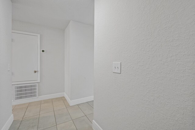 hallway with light tile patterned flooring