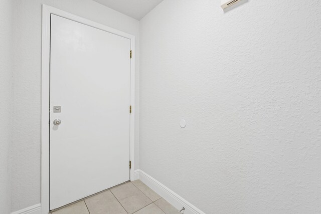 doorway featuring light tile patterned floors