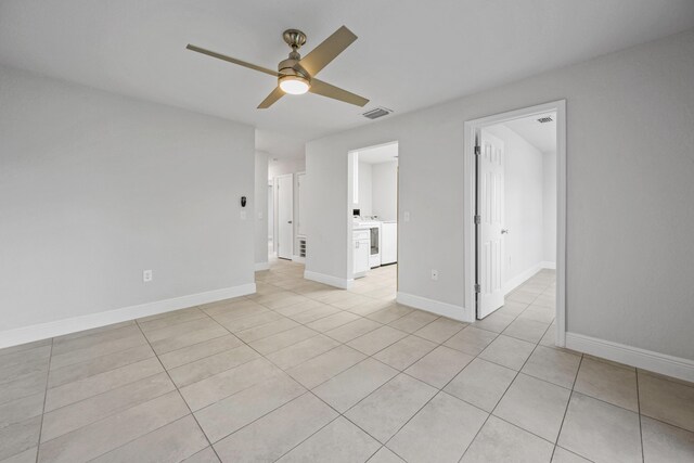 tiled spare room with ceiling fan