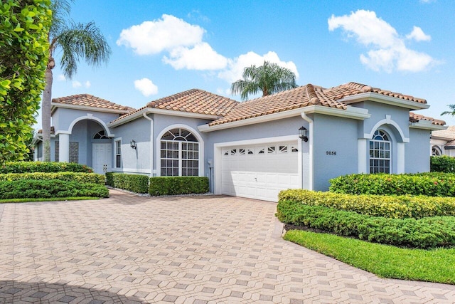 mediterranean / spanish-style home with a garage