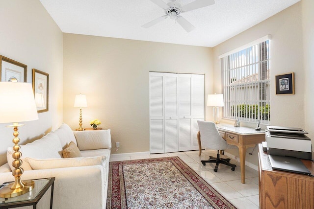 tiled office with ceiling fan and a textured ceiling