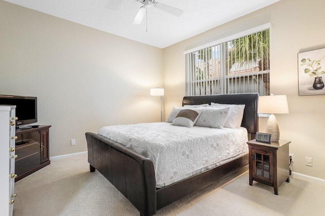 bedroom featuring ceiling fan, a textured ceiling, and light carpet