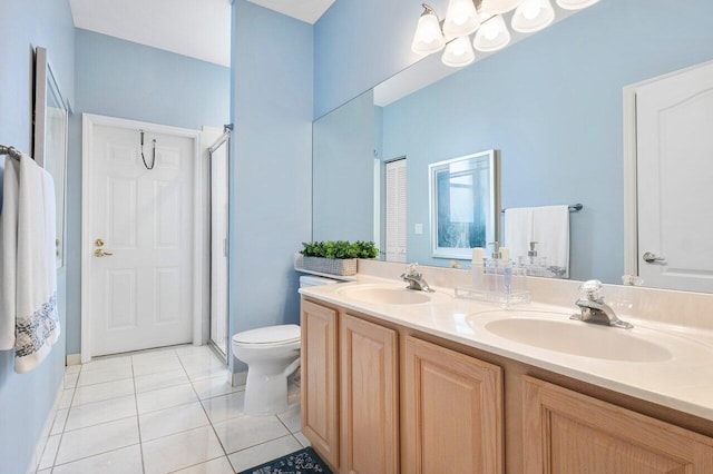 bathroom with tile patterned flooring, walk in shower, vanity, and toilet