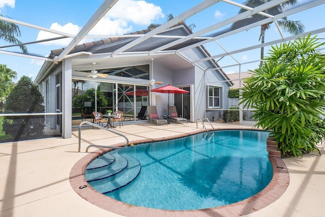 view of pool featuring a lanai, a patio, and ceiling fan