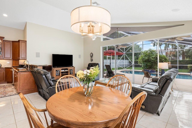 tiled dining room with vaulted ceiling, plenty of natural light, and sink