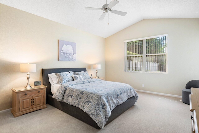 bedroom featuring lofted ceiling, ceiling fan, and light colored carpet