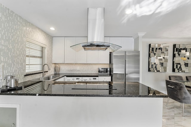 kitchen with white cabinets, sink, island exhaust hood, and stainless steel appliances