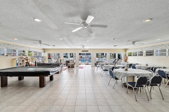 rec room with ceiling fan, light tile patterned flooring, a textured ceiling, and billiards