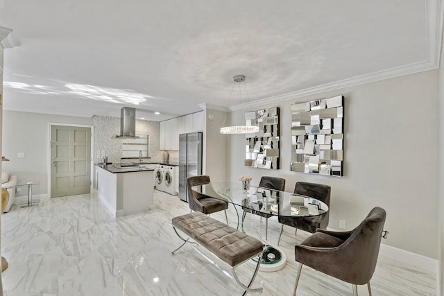 dining space featuring washer and clothes dryer and crown molding