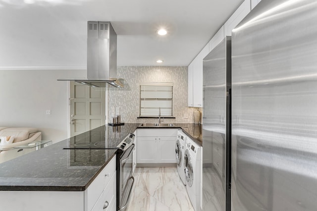 kitchen featuring white cabinets, sink, stainless steel appliances, extractor fan, and washing machine and clothes dryer