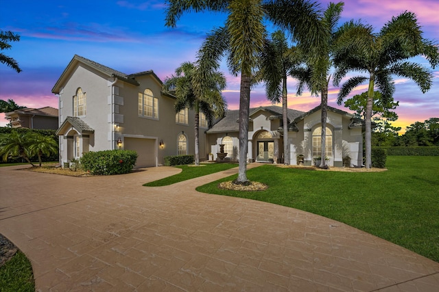 view of front of home featuring a lawn and a garage