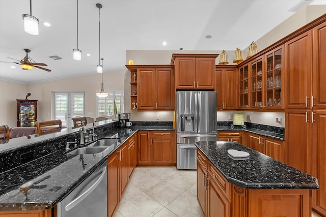 kitchen featuring pendant lighting, vaulted ceiling, appliances with stainless steel finishes, crown molding, and ceiling fan