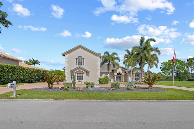 mediterranean / spanish-style house featuring a front lawn