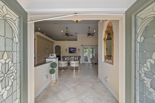 foyer entrance with ceiling fan and french doors