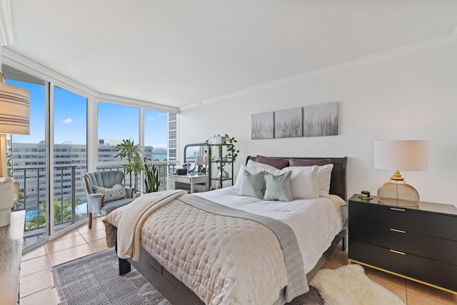 bedroom with light tile patterned floors, crown molding, access to outside, and expansive windows