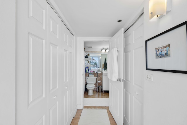 corridor featuring light tile patterned flooring