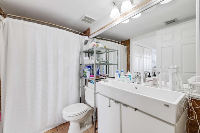 bathroom with vanity, tile patterned flooring, and toilet