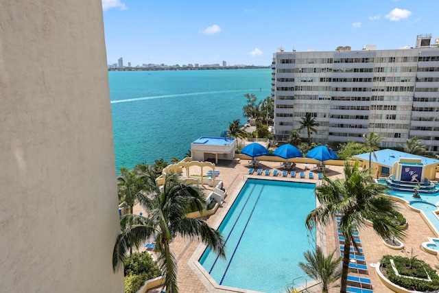 view of pool featuring a patio and a water view