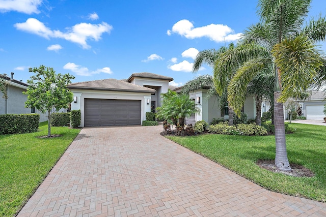 view of front of house with a garage and a front yard