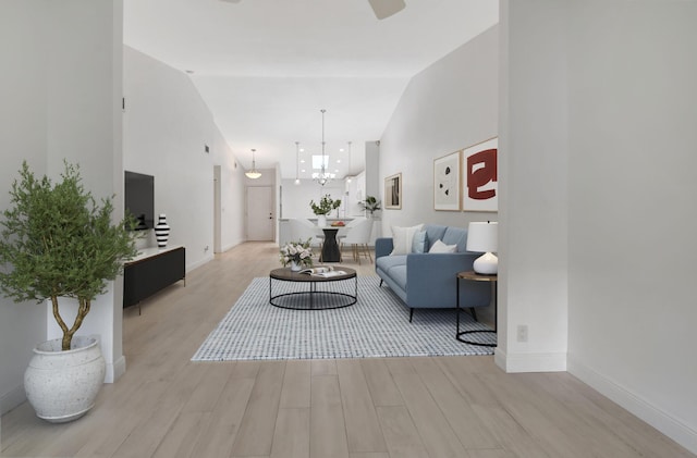 5476 Atlantic Palm Ct Unit B, Boynton Beach, FL 33437 - living room featuring a chandelier, lofted ceiling, and light hardwood / wood-style flooring