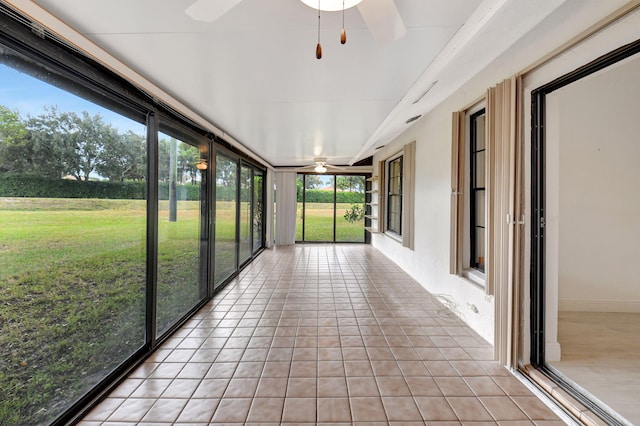 unfurnished sunroom with ceiling fan