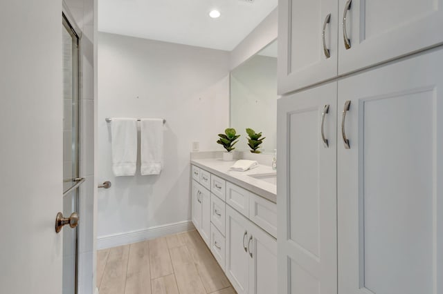 bathroom with hardwood / wood-style floors and vanity