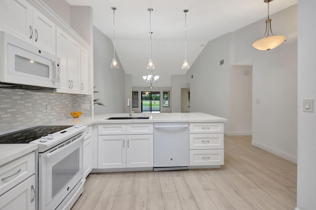 kitchen featuring white appliances, sink, pendant lighting, light hardwood / wood-style flooring, and white cabinets