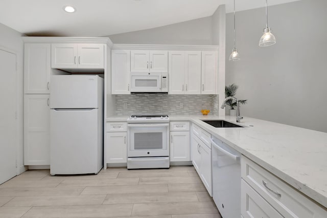 kitchen featuring lofted ceiling, white cabinetry, white appliances, and sink