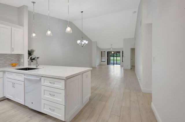 kitchen with white dishwasher, sink, high vaulted ceiling, white cabinets, and light hardwood / wood-style floors