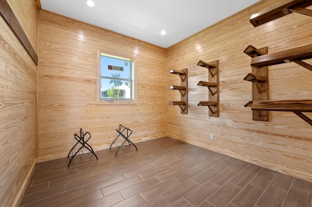 spare room with wooden walls and dark hardwood / wood-style floors