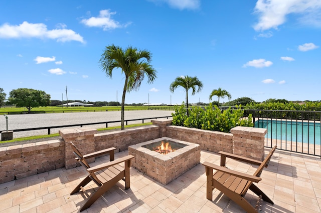 view of patio / terrace featuring a water view and a fire pit