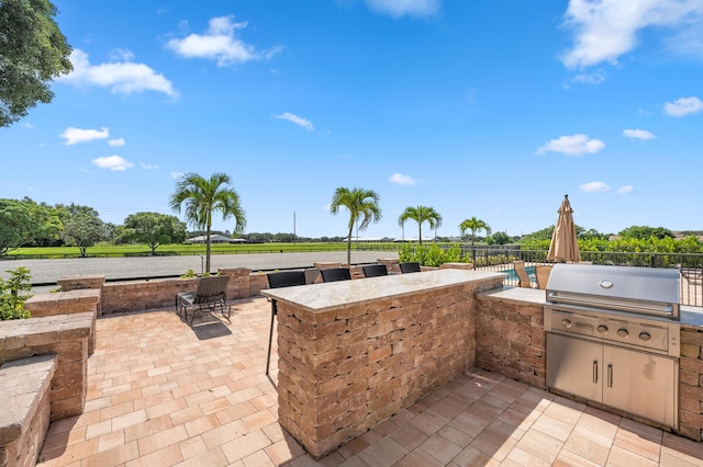 view of patio with area for grilling and exterior kitchen