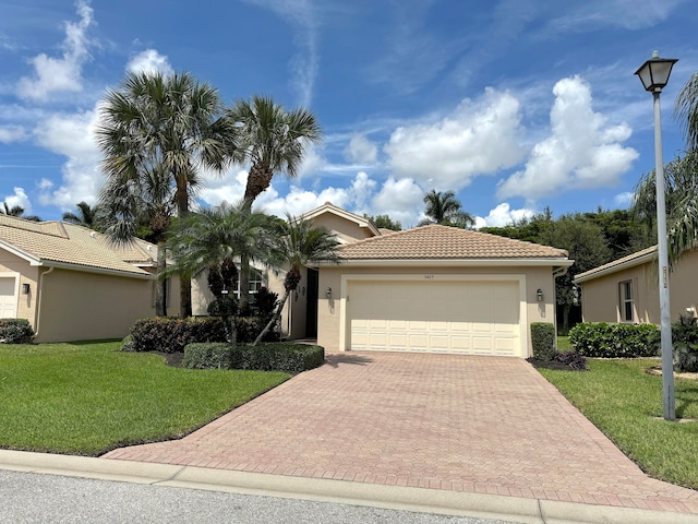 mediterranean / spanish house with a front yard and a garage