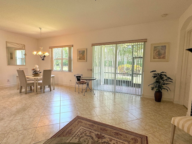 dining room featuring a textured ceiling, light tile patterned floors, and a notable chandelier