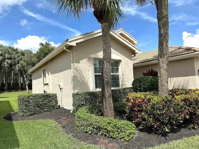 view of property exterior with a lawn