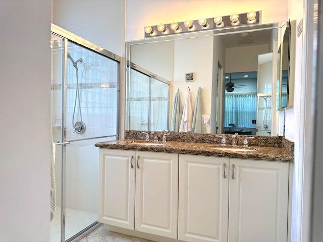 bathroom with vanity, ceiling fan, and a shower with shower door