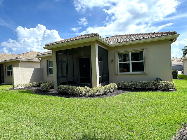 view of front of property featuring a front lawn and a sunroom