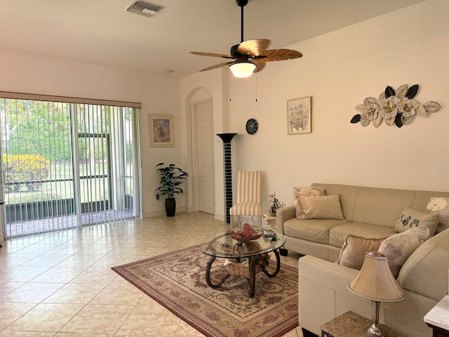 living room with a wealth of natural light, ceiling fan, and light tile patterned flooring