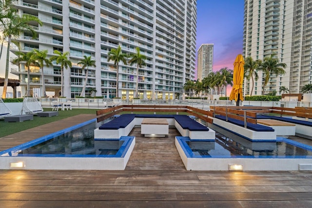 view of pool at dusk