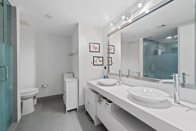 bathroom with vanity, toilet, an enclosed shower, and tile patterned flooring