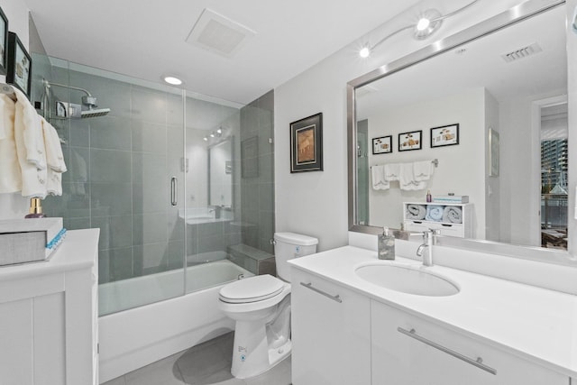 full bathroom with vanity, tile patterned flooring, enclosed tub / shower combo, and toilet