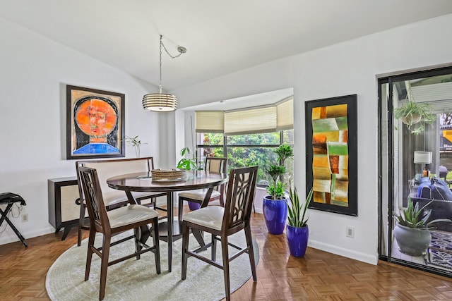 dining area featuring dark parquet floors