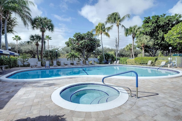 view of pool with a community hot tub and a patio