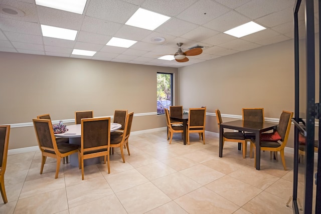 tiled dining room featuring a paneled ceiling and ceiling fan