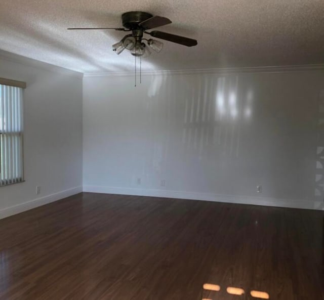 empty room featuring a textured ceiling, crown molding, ceiling fan, and dark hardwood / wood-style floors