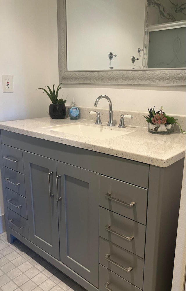 bathroom with tile patterned floors and vanity