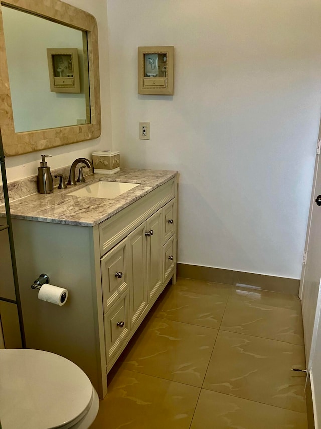 bathroom featuring vanity, toilet, and tile patterned floors