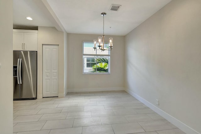 unfurnished dining area with light tile patterned floors and a chandelier