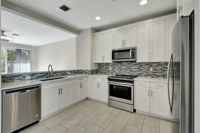 kitchen with white cabinetry, sink, and stainless steel appliances